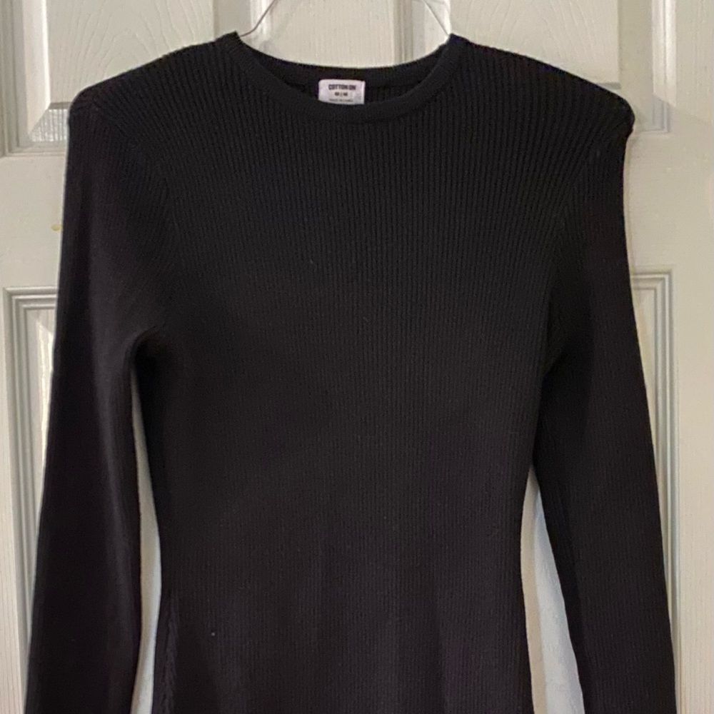Black long sleeve, fitted dress.
